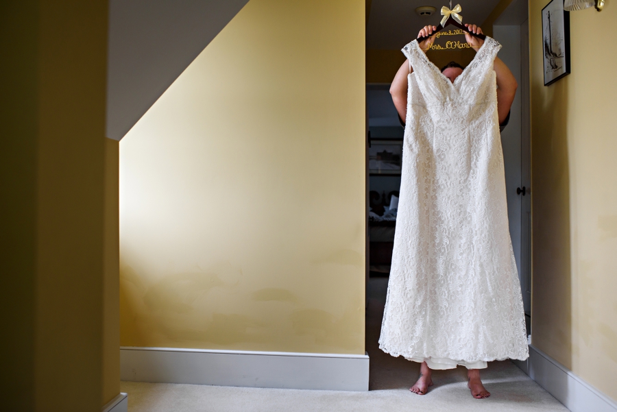A bride holding her wedding dress.